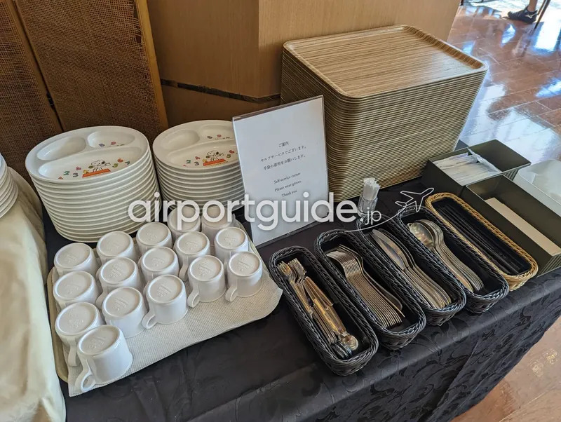 セルフサービス用食器コーナー。皿・マグ・カトラリー・トレイが並ぶ。